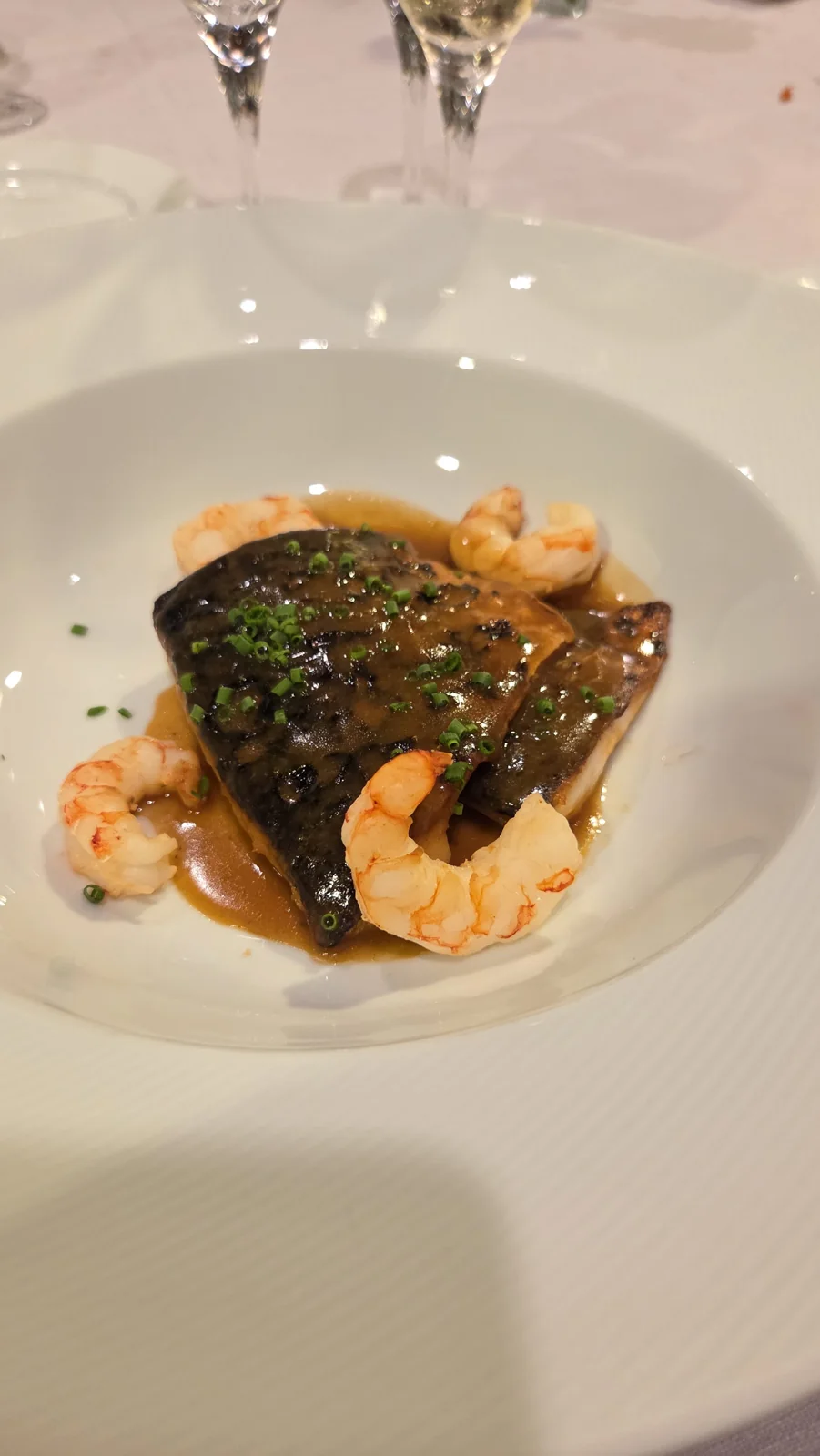 Seared fish with prawns and chives — illustrative seafood photography
